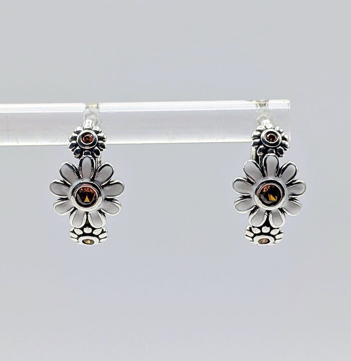 Floral sterling silver hoop earrings with amber stones on white background