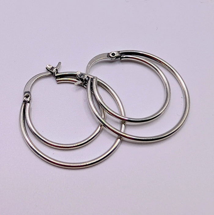 Close-up view of 925 sterling silver double hoop earrings showing the polished finish.