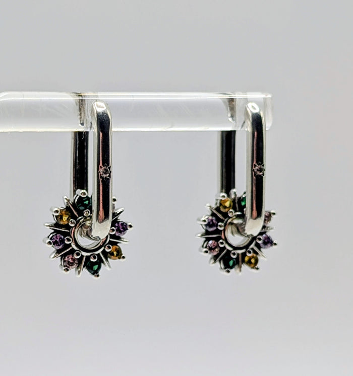 Close-up showing the detail of the Sterling Silver oblong hoop and the vibrant, sparkly multi-color CZ gems on the starburst charm.