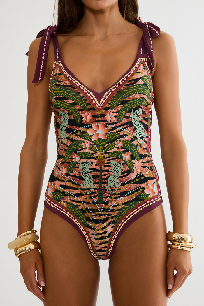 Jungle print one piece swimsuit on a woman with a white background