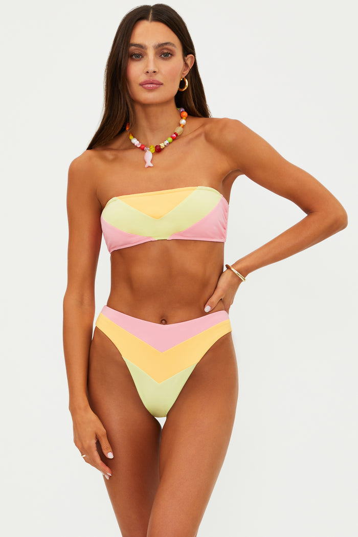 Woman wearing a colorful bikini set on a white background