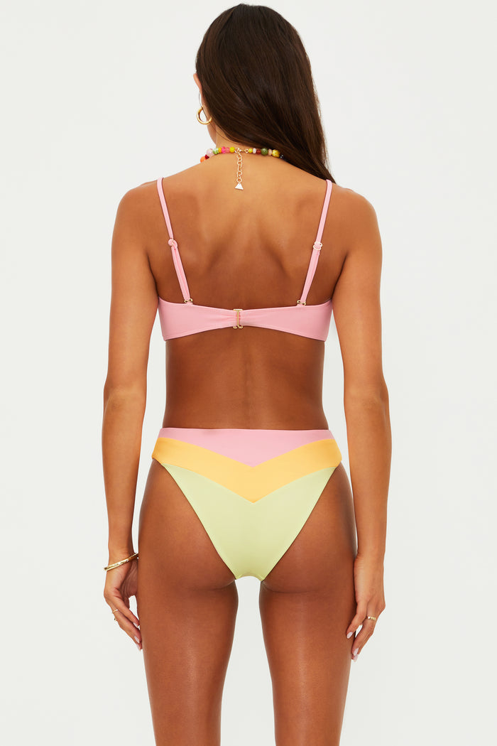 Woman wearing a colorful bikini set on a white background