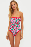 Woman wearing a strapless one piece with pink and red cherries.