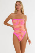Woman wearing a strapless swimsuit with pink and orange pattern on a white background
