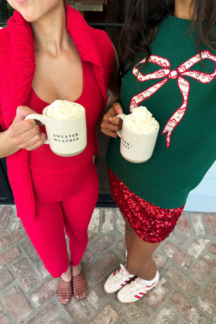 green sweater with red bow detail