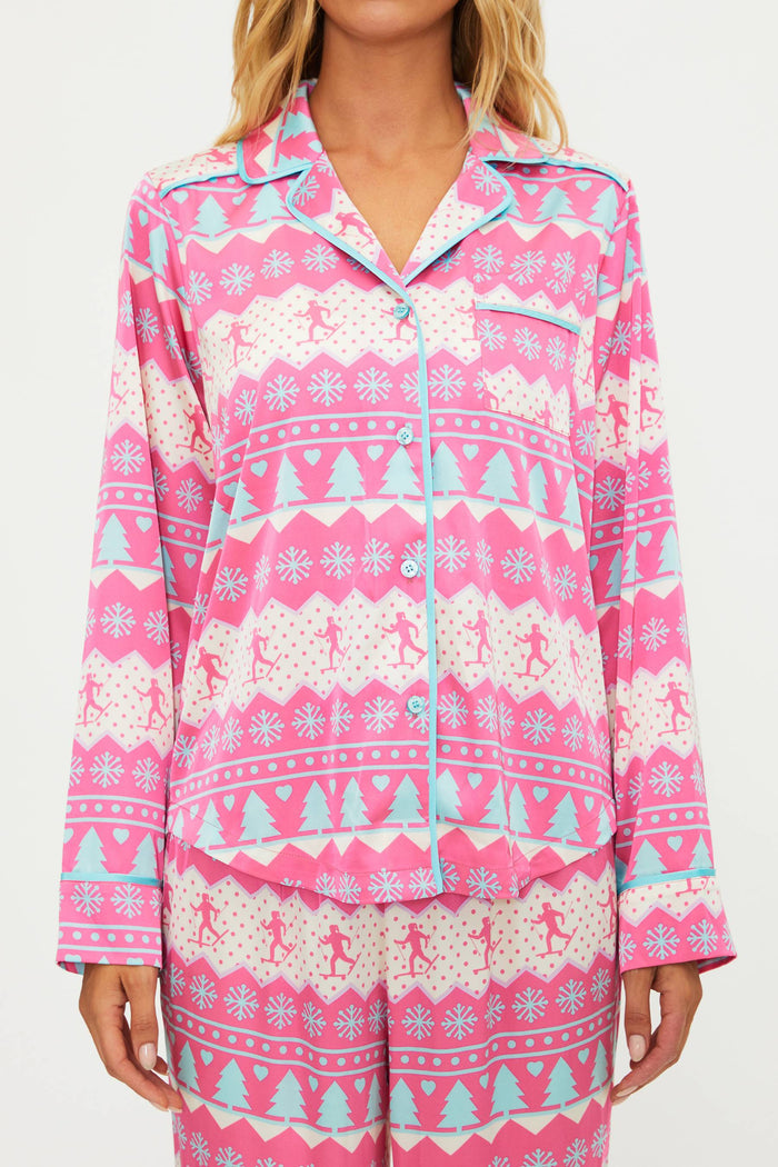 Pink pajama set with Christmas pattern worn by a person
