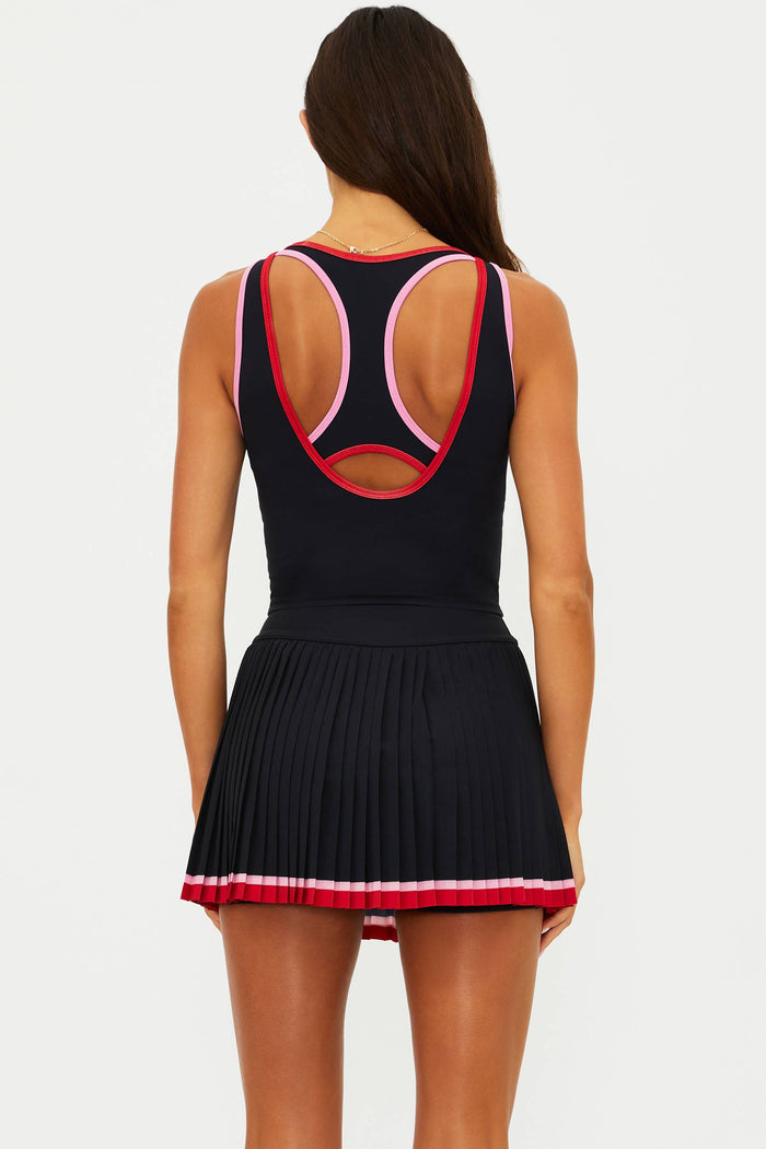 Woman wearing a black top with red and pink lining.