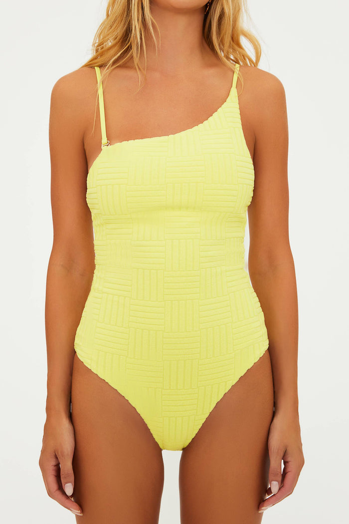 A model wearing a yellow one-piece swimsuit with adjustable straps and a shelf bra.