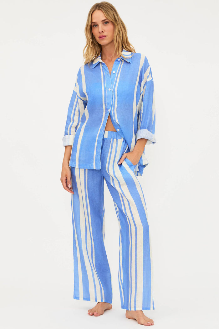 Woman wearing a blue and white striped pajama set on a white background