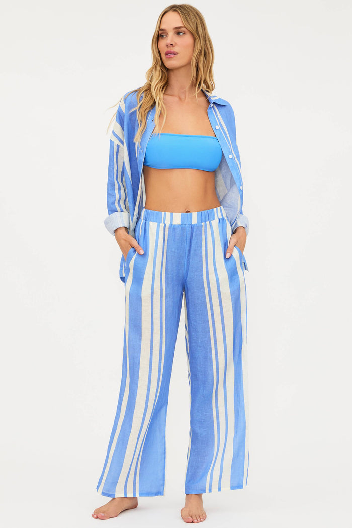 Woman wearing a blue and white striped outfit on a white background
