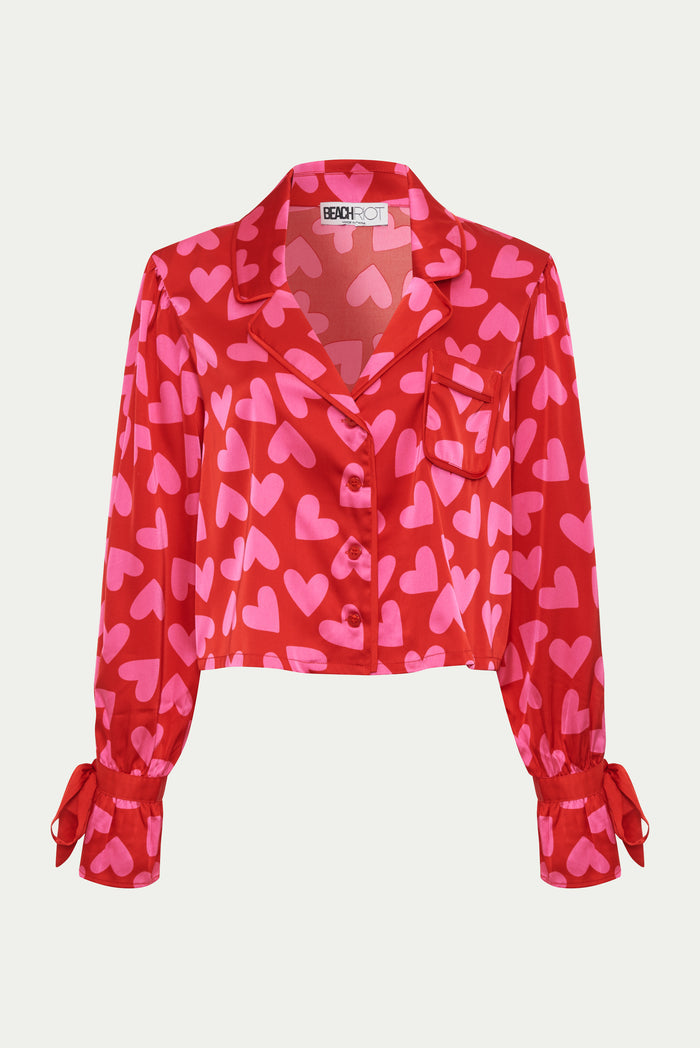 wearing red and pink silk, shot and longsleeve pjs.