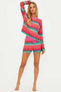 Woman wearing a colorful striped outfit on a white background