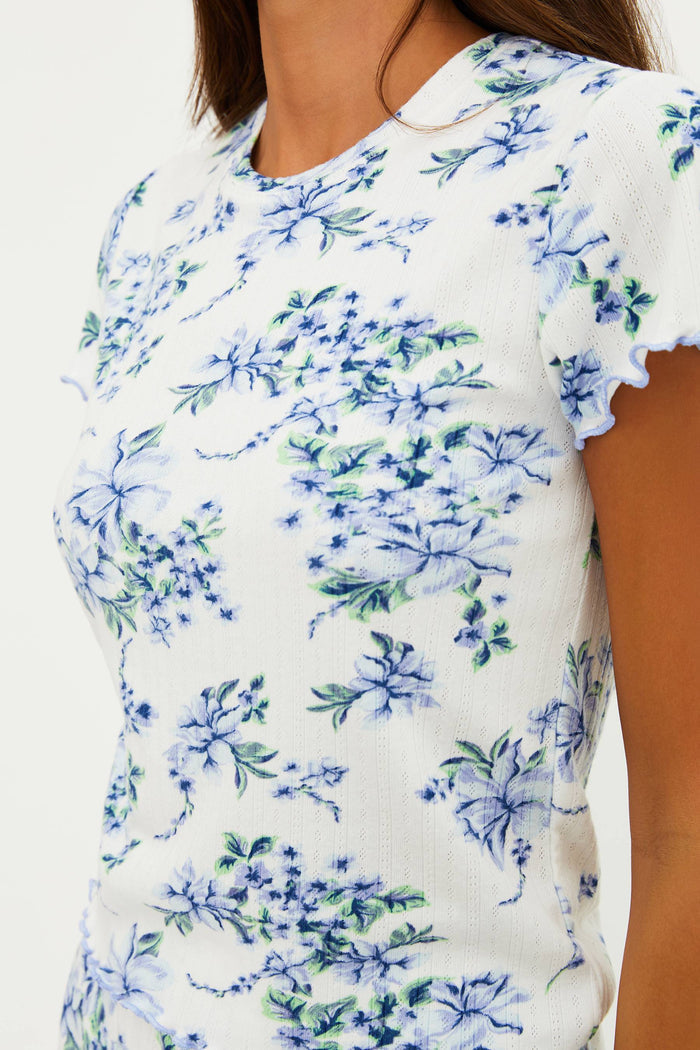 White top with blue floral pattern worn by a person