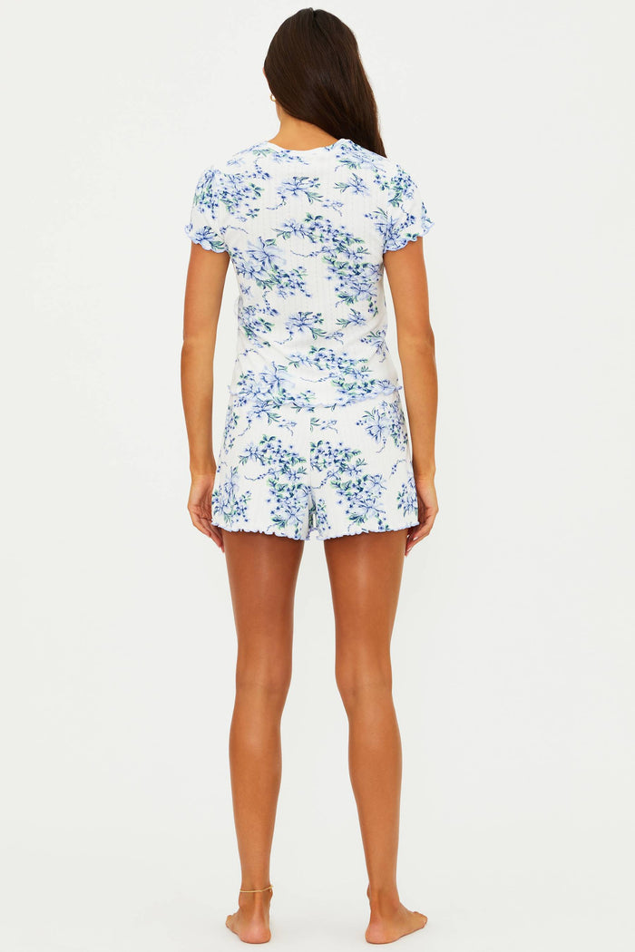 Woman wearing a floral pajama set on a white background