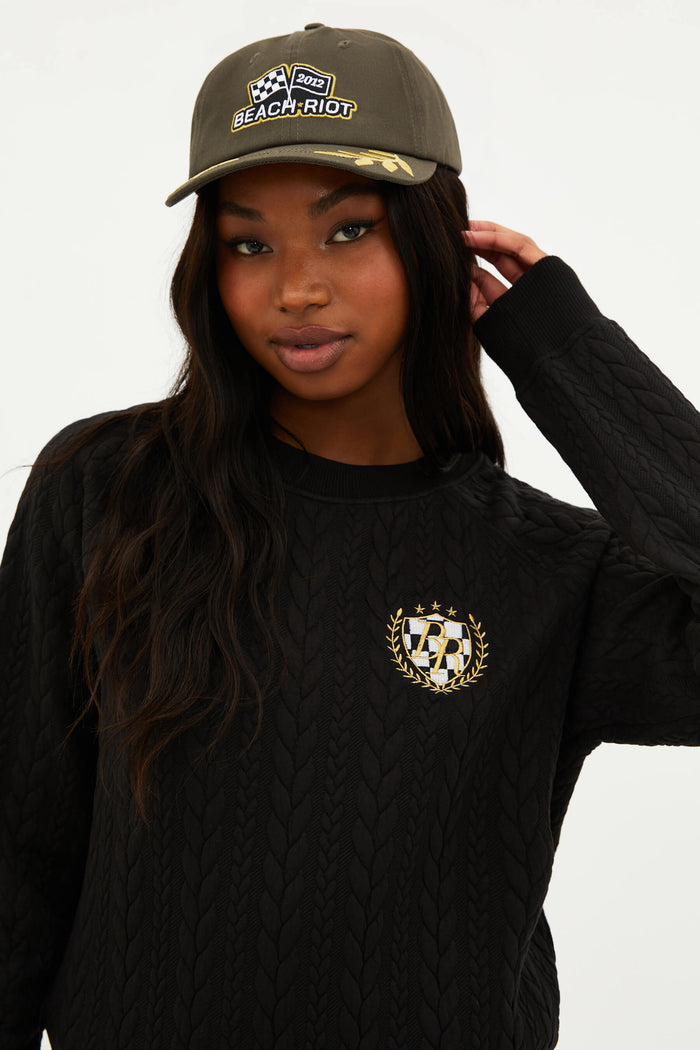 An olive green dad hat with the Beach Riot logo on the front and decorative yellow embroidery on the sides.