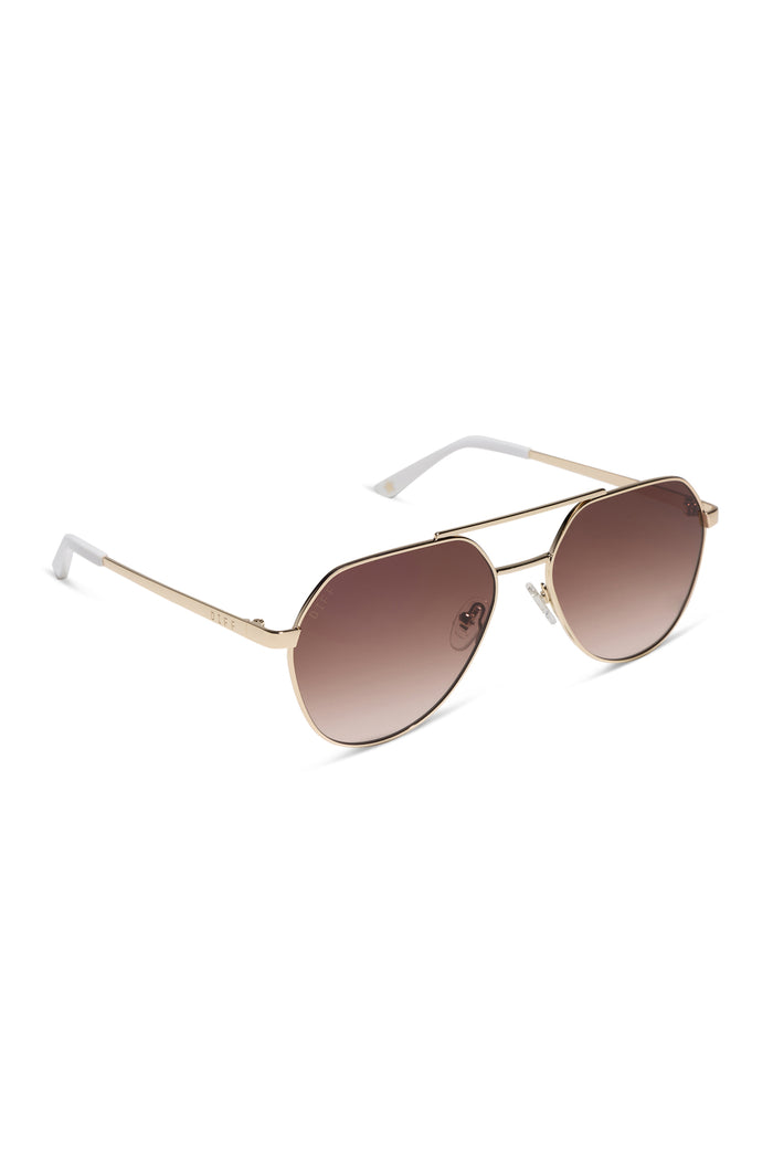 Woman wearing aviator sunglasses with a plain background