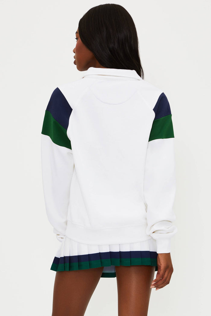 White sweatshirt with green and navy accents worn by a person on a white background