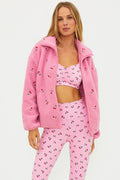 Pink sherpa with red cherries on it.