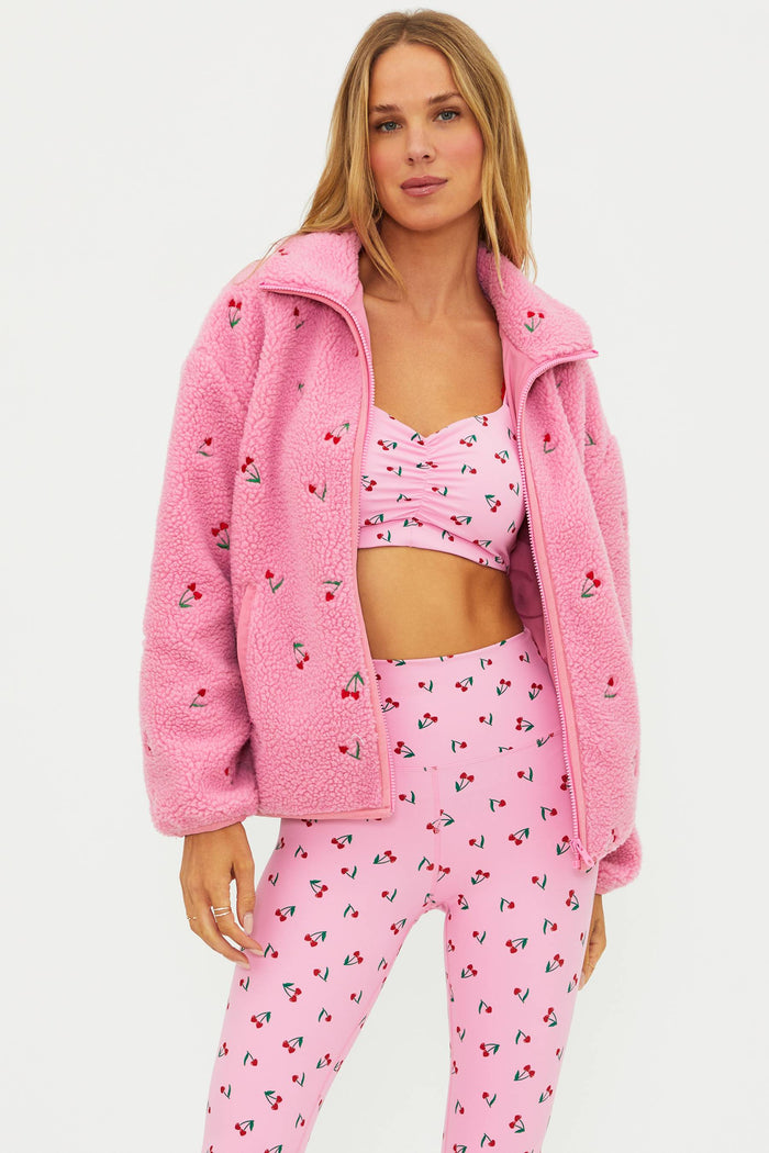 Pink sherpa with red cherries on it.