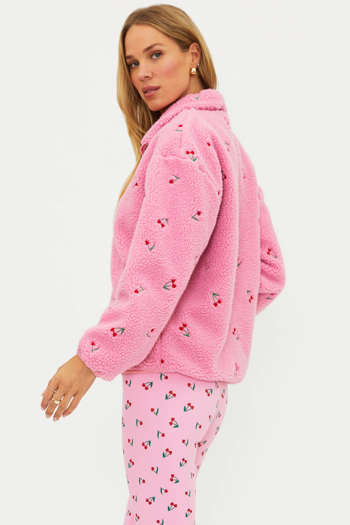 Pink sherpa with red cherries on it.