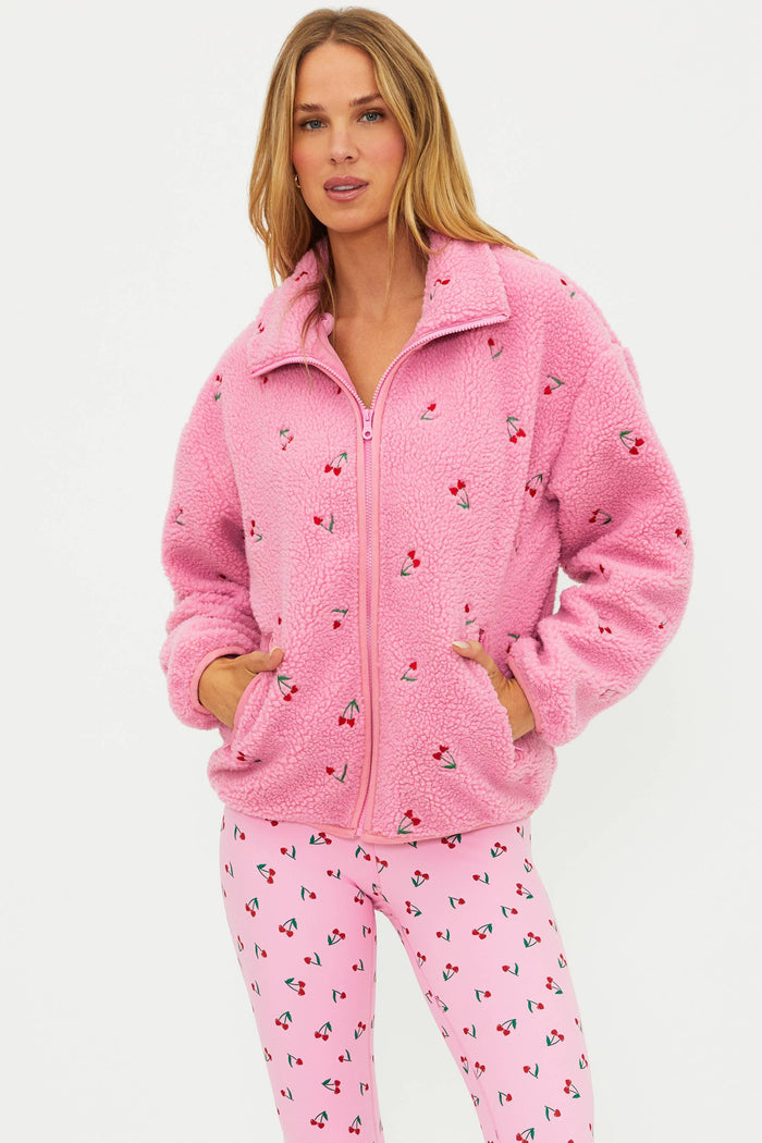 Pink sherpa with red cherries on it.