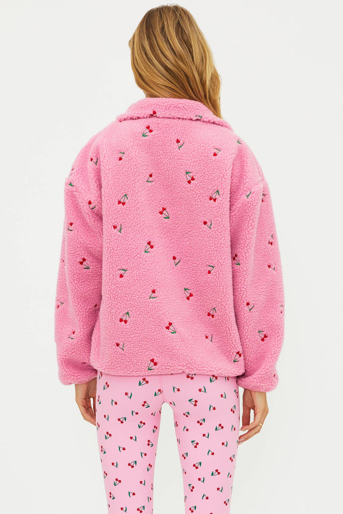 Pink sherpa with red cherries on it.