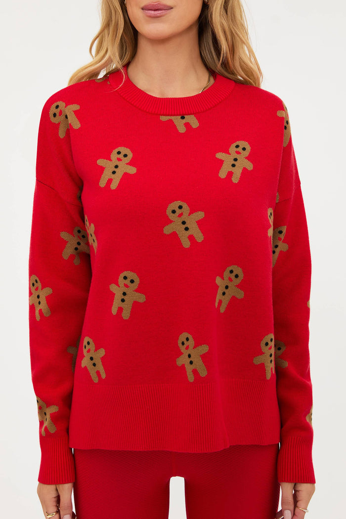 Red sweater with gingerbread man patterns on a white background