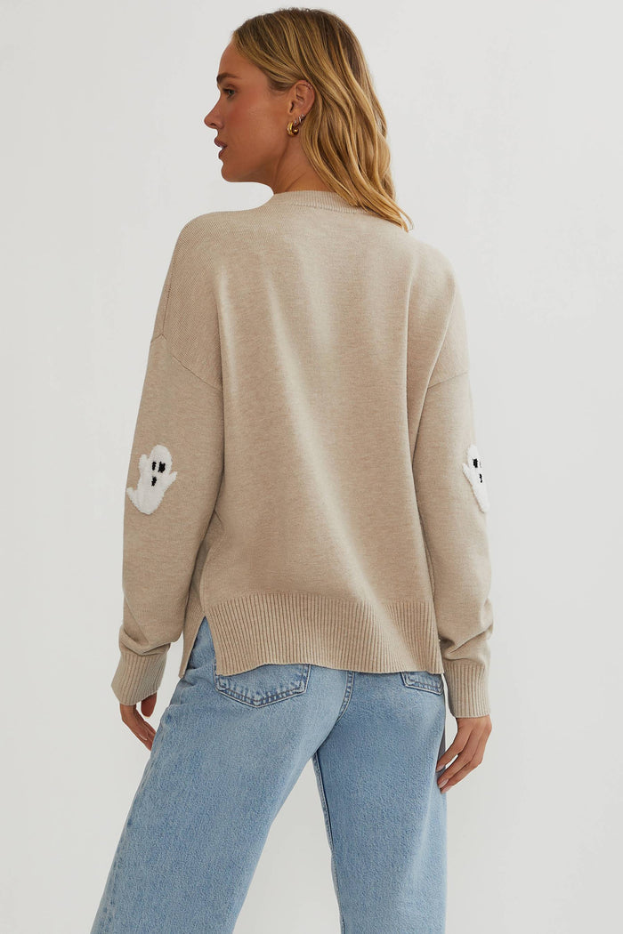 Oatmeal sweater with little white ghosts.