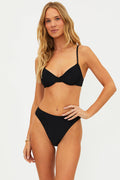 This image features the Camilla Top Black, a stylish and supportive swimwear top. The model is wearing the top in size small, showcasing its fit and design.