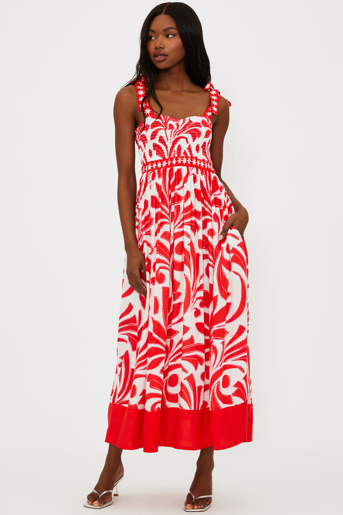 Woman wearing a red and white patterned dress on a white background