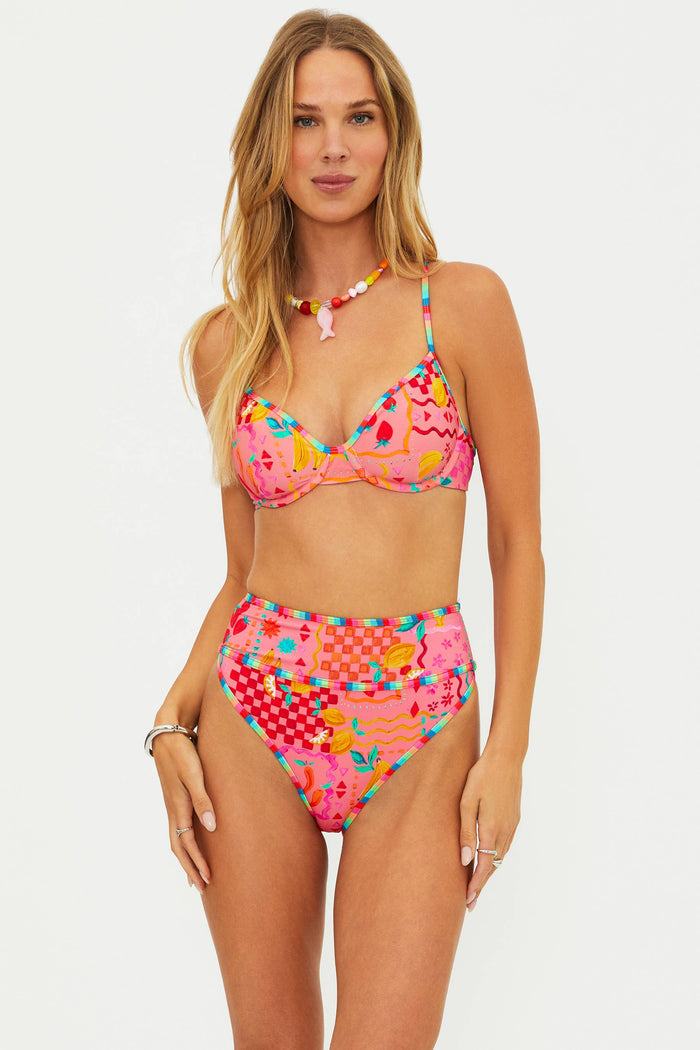 Woman wearing a colorful bikini set on a white background