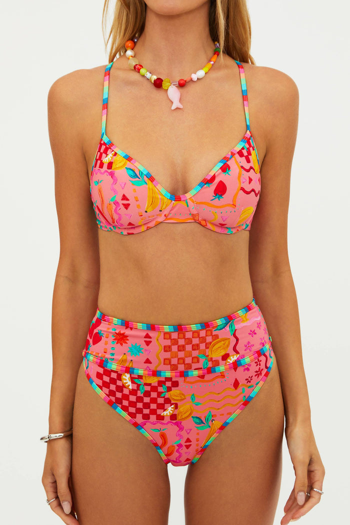 Woman wearing a colorful bikini set with a white background