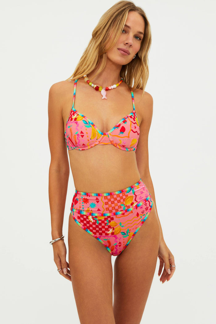 Woman wearing a colorful bikini set on a white background