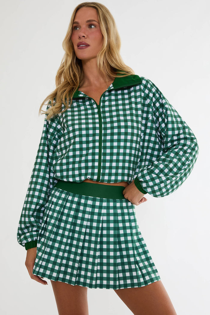 Woman wearing a green and white checkered outfit on a white background