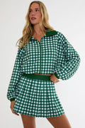 Woman wearing a green and white checkered outfit on a white background