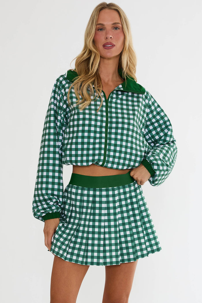 Woman wearing a green and white checkered outfit on a white background