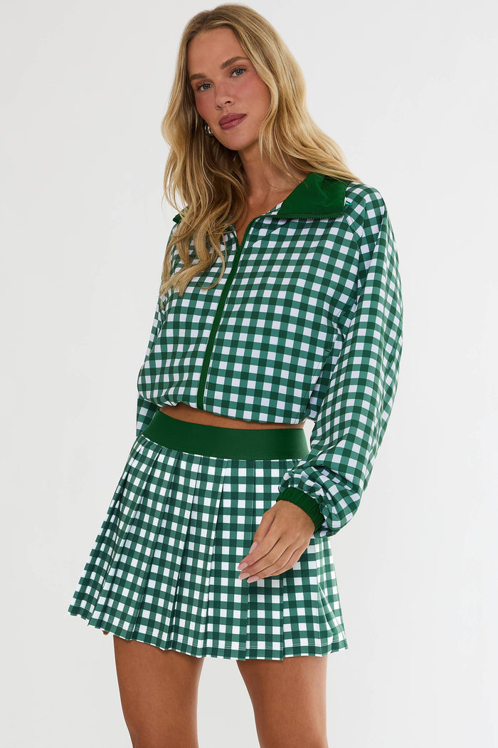 Woman wearing a green and white checkered outfit on a white background