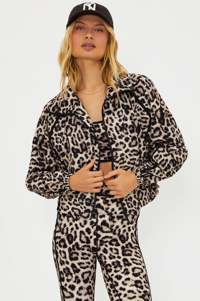 Woman wearing a leopard print outfit with a plain background