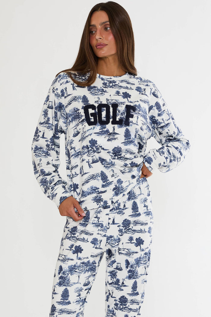 Person wearing a blue and white patterned outfit with 'GOLF' text on a white background