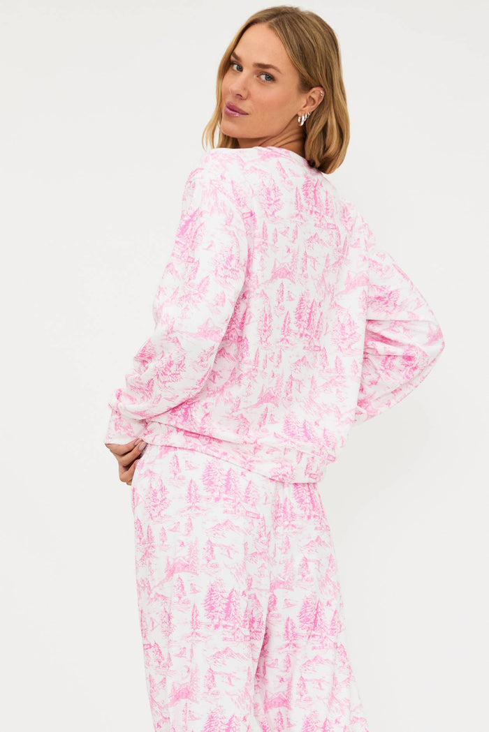 Woman wearing a pink and white tie-dye outfit on a plain background