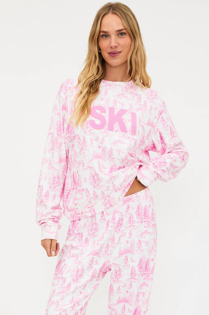 Woman wearing a pink tie-dye outfit with 'SKI' text on a white background