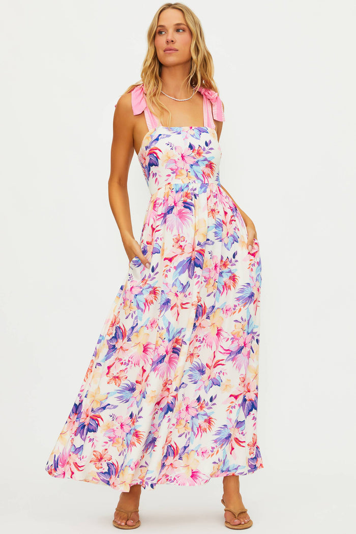 Woman wearing a colorful floral dress on a white background