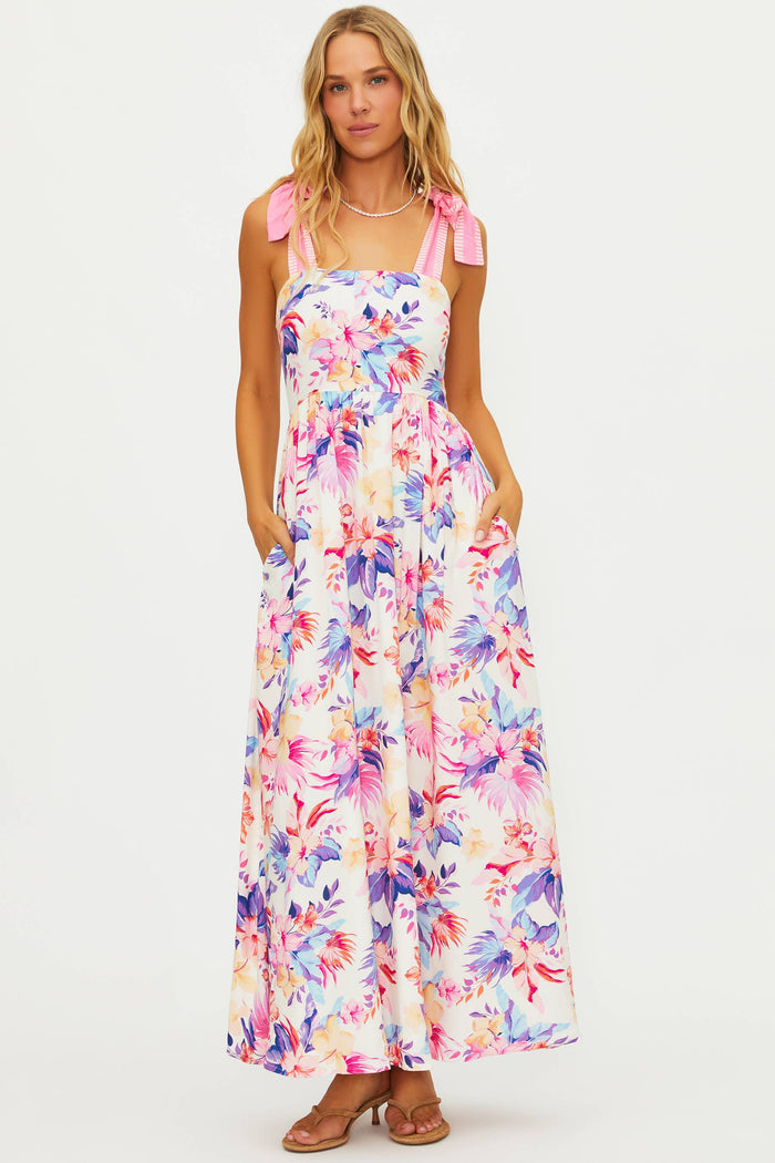Woman wearing a colorful floral dress on a white background