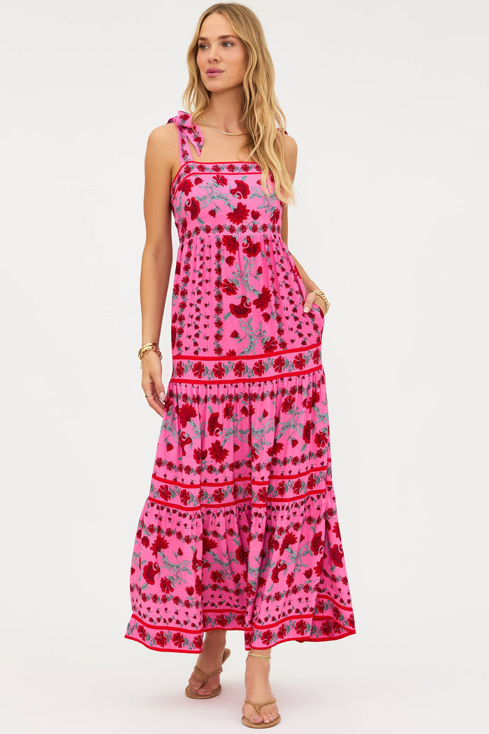 Woman wearing a pink floral dress on a white background