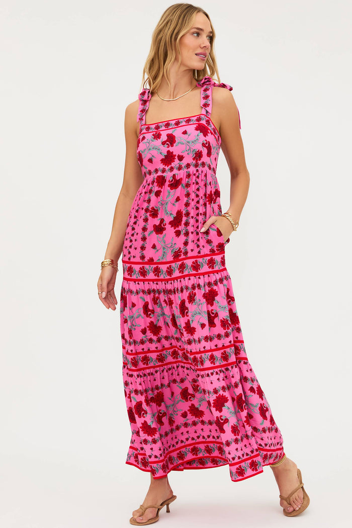 Woman wearing a pink patterned dress on a white background