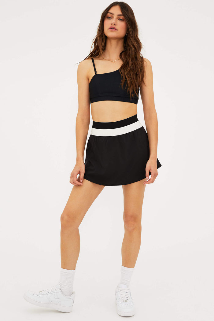 Black pleated skirt with white band.