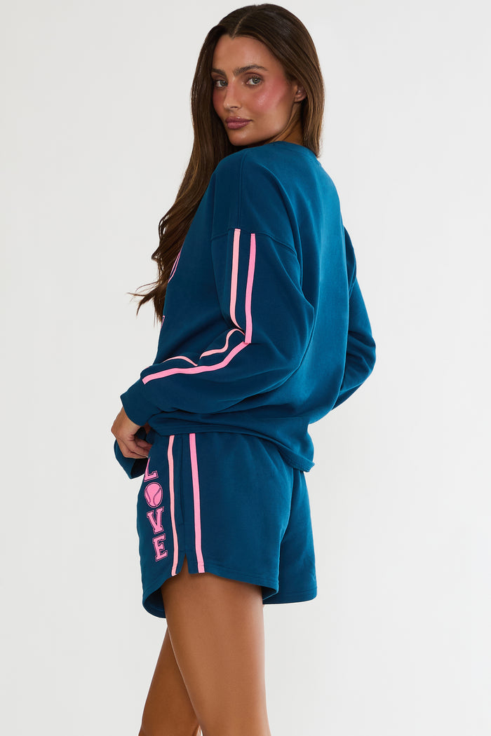 Navy sweatshirt with "Love" tennis text in pink.