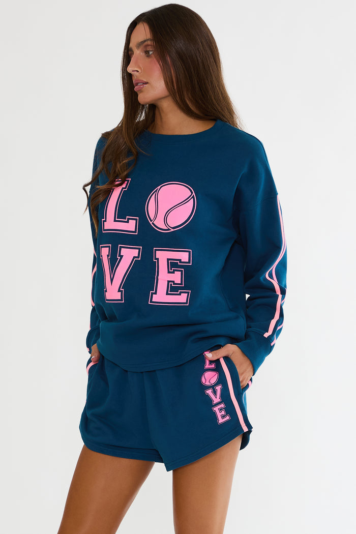 Navy sweatshirt with "Love" tennis text in pink.