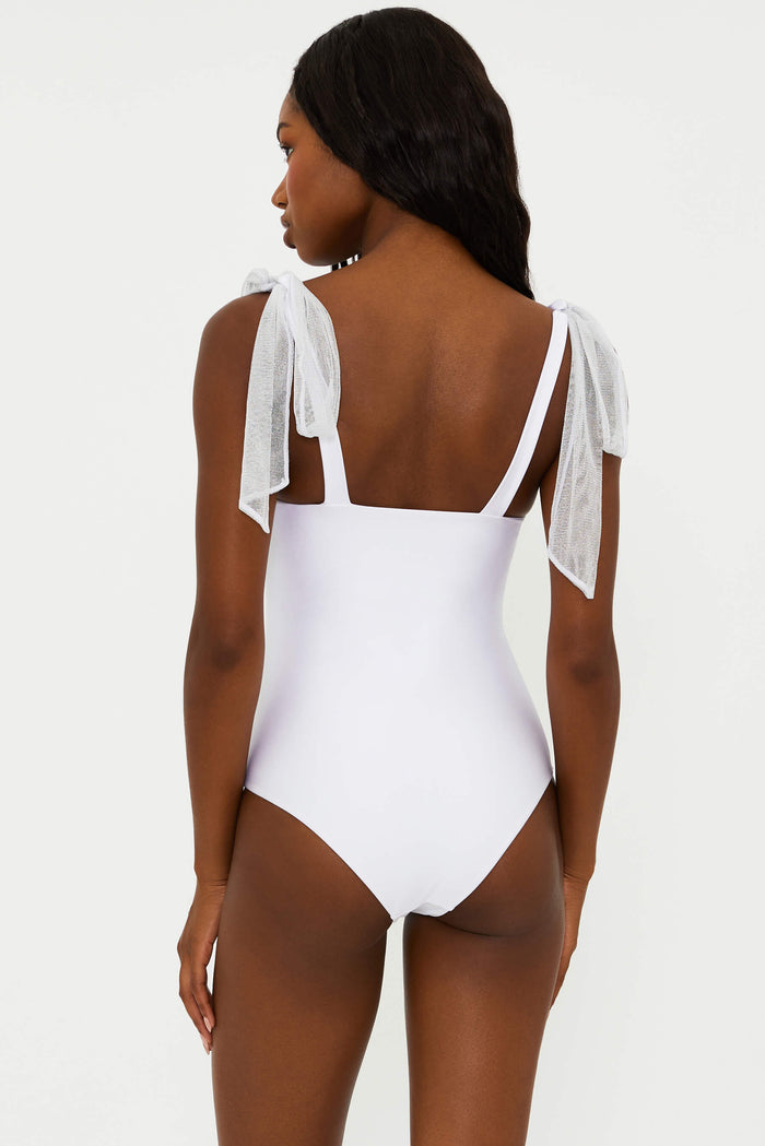 A white one-piece swimsuit with delicate straps that tie at the shoulders and ruched underwire cups with metallic threading.