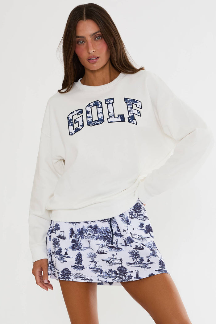 White sweatshirt with blue golf texting.